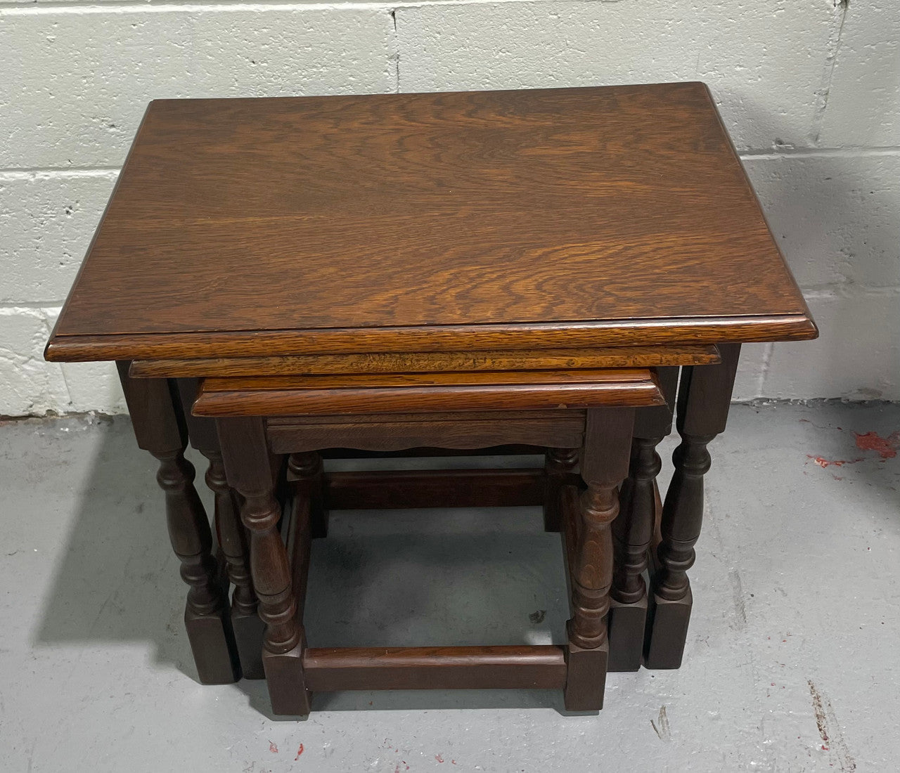 Tudor style English dark Oak nest of three tables. They are in good restored condition.