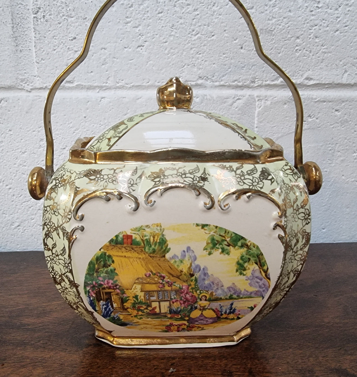 Charming Sadler Biscuit Barrel Decorated With a Thatched Cottage & Lady In Garden