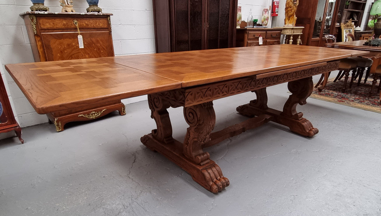 Amazing French Oak Renaissance style parquetry top extension table. Beautiful parquetry top and amazing detailed carvings on the legs. It extends to 306 cm long when fully extended. Sourced from France and in good original detailed condition.