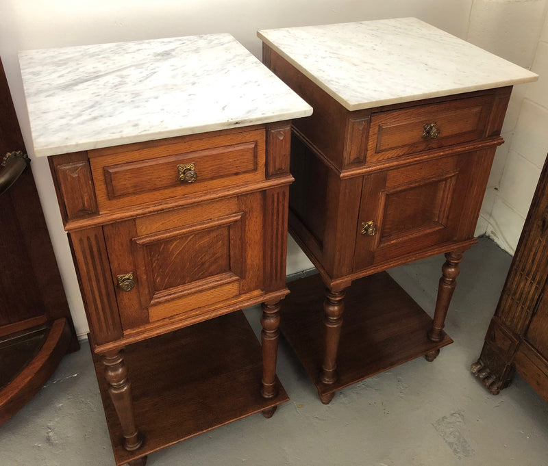 A lovely pair of French Oak, marble top bedside cabinets with a cupboard and drawer in good original condition.