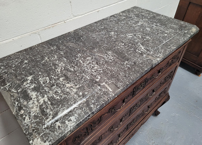 French Oak Louis XV style marble top chest of three drawers. It has beautiful carvings on the drawers with lovely decorative handles all toped with a stunning black and white marble top. In good original detailed condition.