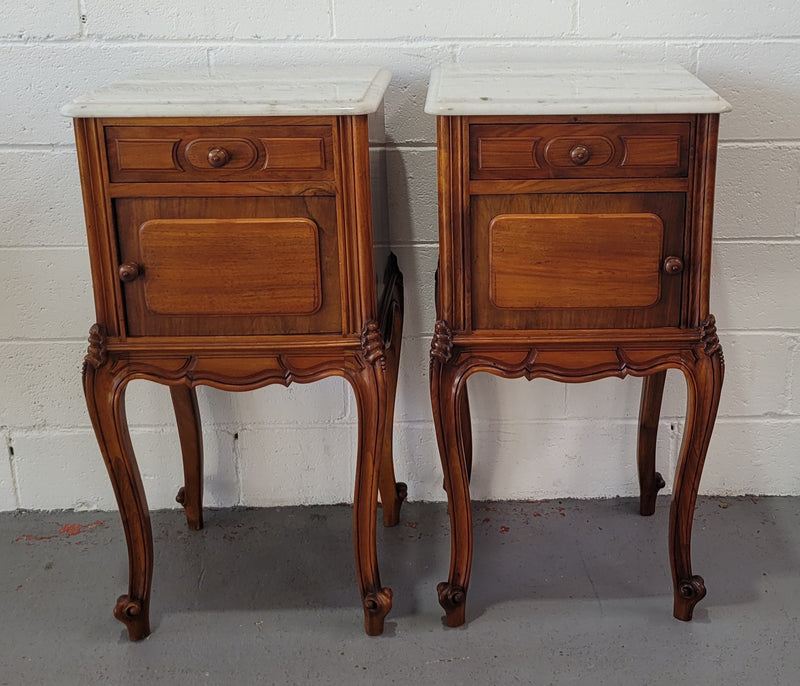 Pair of stunning Louis XV style French Walnut white marble top bedside cabinets. They have one drawer and a cupboard that is marble lined. The marble has been polished and they are in good original detailed condition.