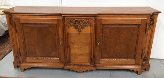 19th century French Oak three door, two drawers buffet with beautiful detailed carving. In good original detailed condition.