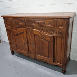 French Walnut two door buffet with parquetry top. It has two drawers and an adjustable shelf. In good original detailed condition and it has been sourced from France.