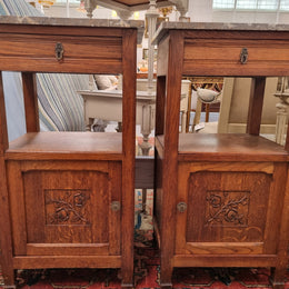 Charming pair of French Oak Arts and Crafts bedsides with shelf, cupboard with carving and marble top.  They have been sourced from France and are in good original detailed condition.