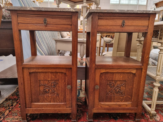Charming pair of French Oak Arts and Crafts bedsides with shelf, cupboard with carving and marble top.  They have been sourced from France and are in good original detailed condition.