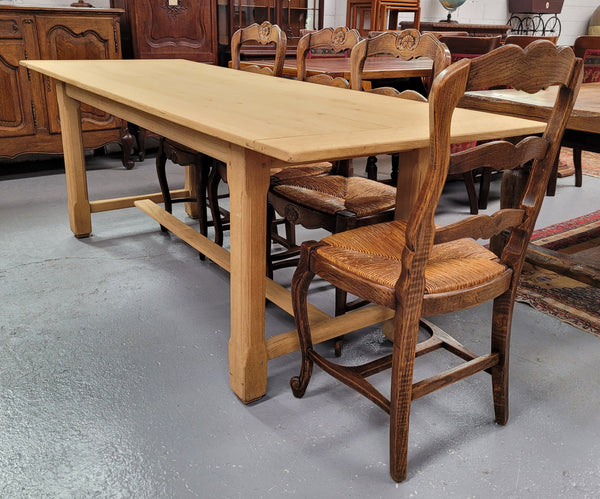 French raw Oak stretcher based refectory table. Features raw wood that could be used as is for a distressed look, or finished and waxed for a more refined look. Sourced from France and in good original condition.