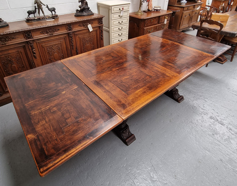 Renaissance style Oak extension table with parquetry top and twin pedestal base. The table extends by pulling out an extension leaf either side making it 287 cm long. Sourced from France and in good original detailed condition.