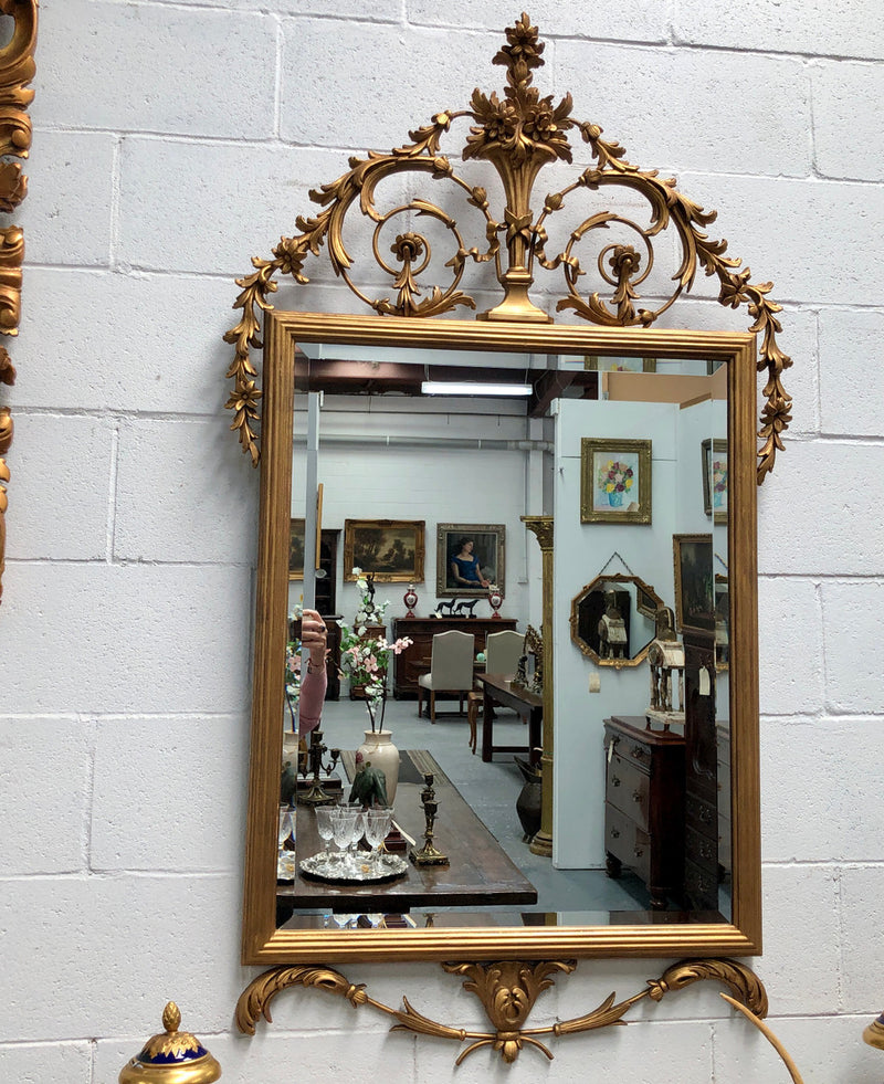 Mid 20th Century Italian gilt wood framed gold wall mirror. Highly decorative carving with a bevelled mirror. Is in good original condition.Mid 20th Century Italian gilt wood framed gold wall mirror. Highly decorative carving with a bevelled mirror. Sourced directly from France and is in good original condition.