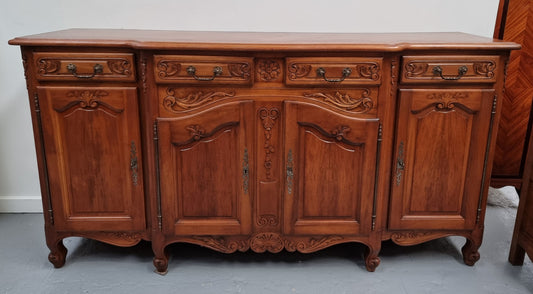 French parquetry top Cherry Wood four-door and four-drawer sideboard. Very decorative carving and is in good original condition.