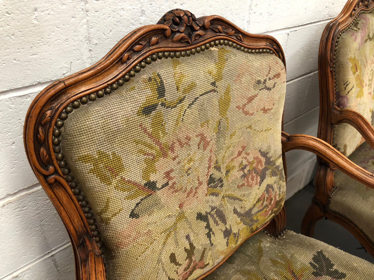 Pair of French Walnut Tapestry covered armchairs. They are in good original detailed condition. Slight wear and tear to fabric but still in good condition please view photos.
