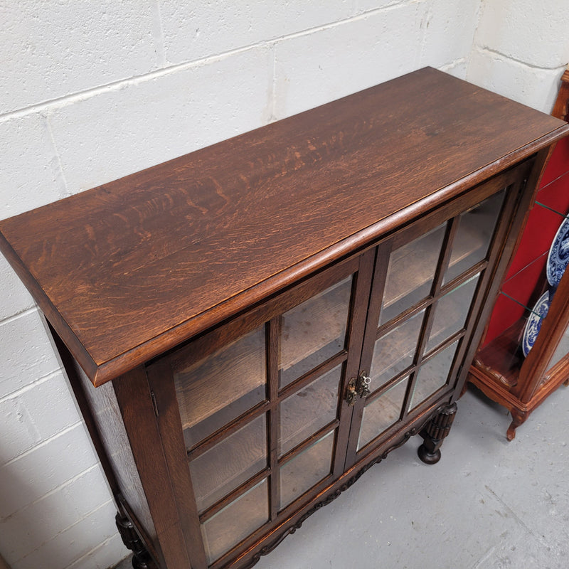 Tudor oak 2 door astral glaze and beveled glass bookcase.  Good original condition. Circa 1930s.