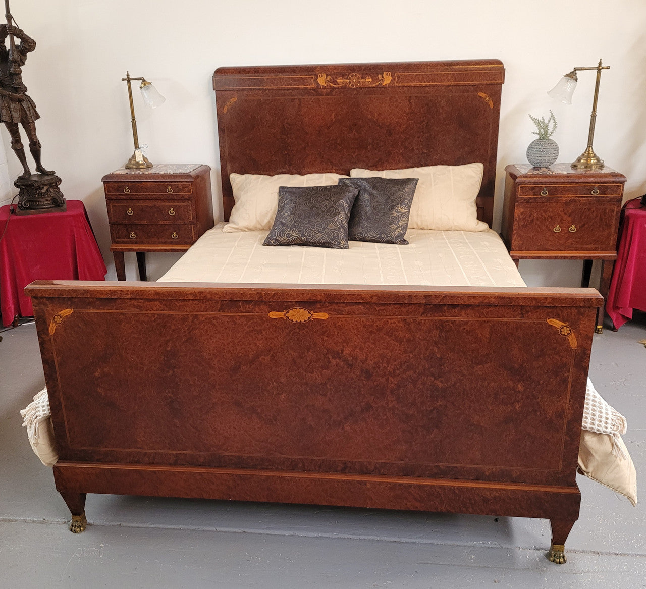 French Art Deco bedroom suite consisting of queen size bed in Amboyna wood and featuring pretty inlay. It comes with a matching pair of bedsides. It is a very stylish and high quality suite. It has been sourced from France and is in good original detailed condition.