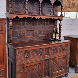 Impressively carved 18th Century English Oak kitchen dresser in 17th Century Jacobean style. It is in good original detailed condition and has been sourced from France.