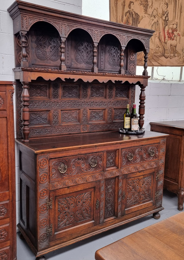 Impressively carved 18th Century English Oak kitchen dresser in 17th Century Jacobean style. It is in good original detailed condition and has been sourced from France.