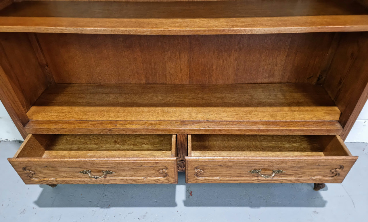 Lovely French Oak Louis XV style open shelf bookcase with two drawers for storage and three shelves in good original detailed condition.