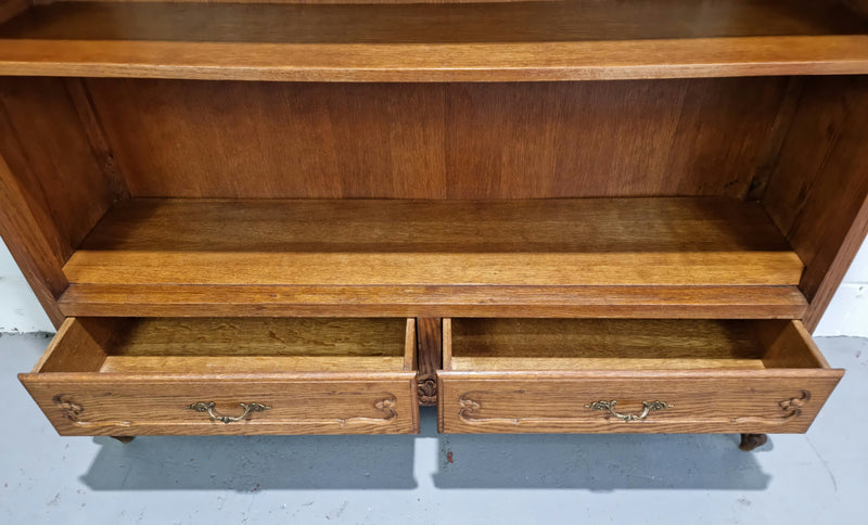 Lovely French Oak Louis XV style open shelf bookcase with two drawers for storage and three shelves in good original detailed condition.