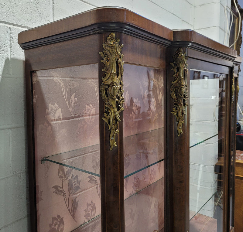 Beautiful French Louis XV style large walnut display cabinet with lovely ormolu mounts . There are two glass shelves and has its original dusky pink fabric in good condition.