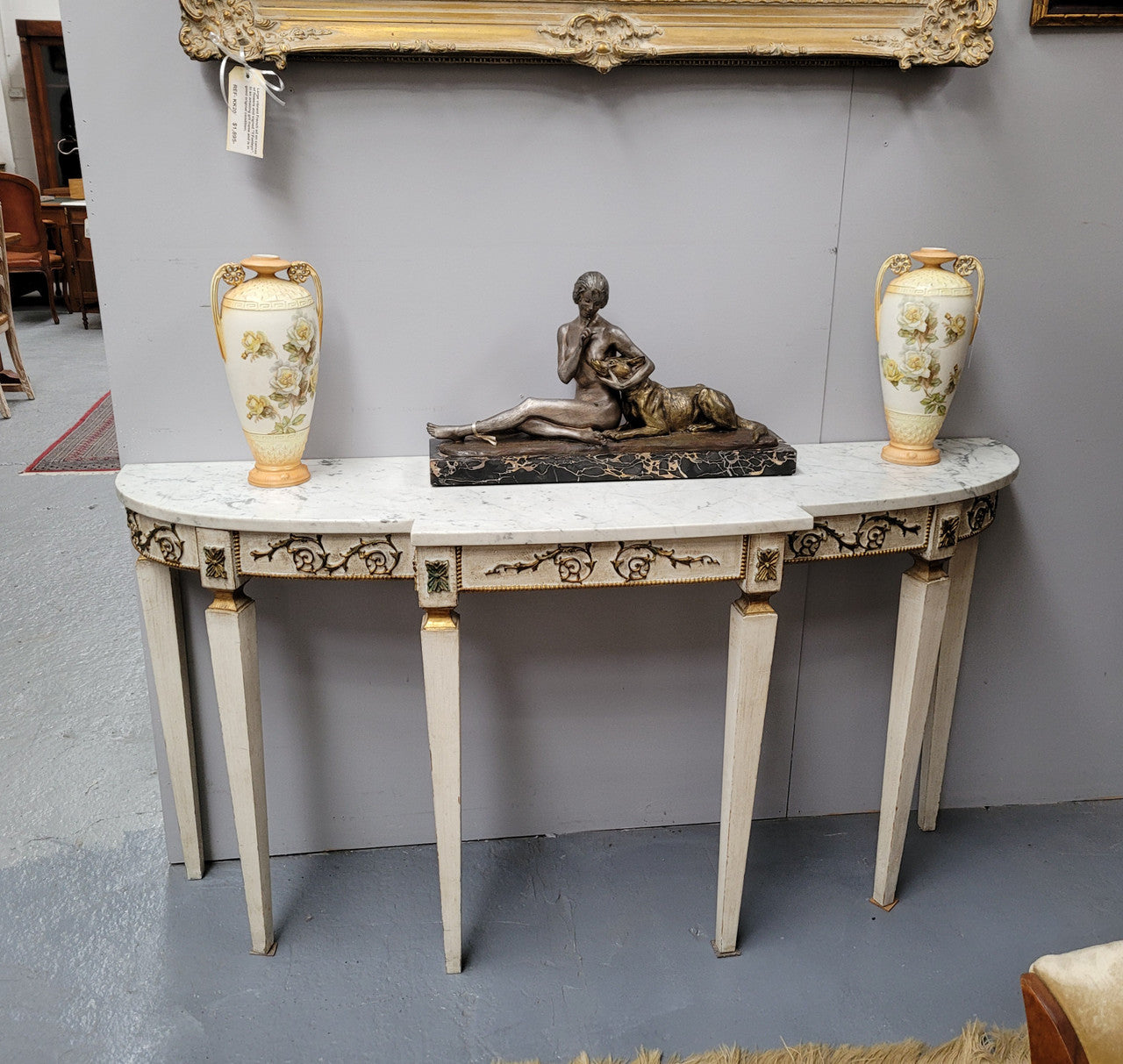 French Louis XVI style painted marble top console table. It is of pleasing narrow proportions and has been sourced from France. It is in good original detailed condition.