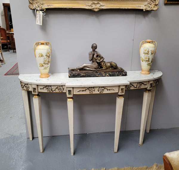 French Louis XVI style painted marble top console table. It is of pleasing narrow proportions and has been sourced from France. It is in good original detailed condition.