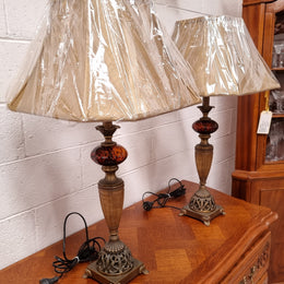 Beautiful pair of metal and glass lamp bases with new gold shades. They are in good original working condition and have been sourced locally.