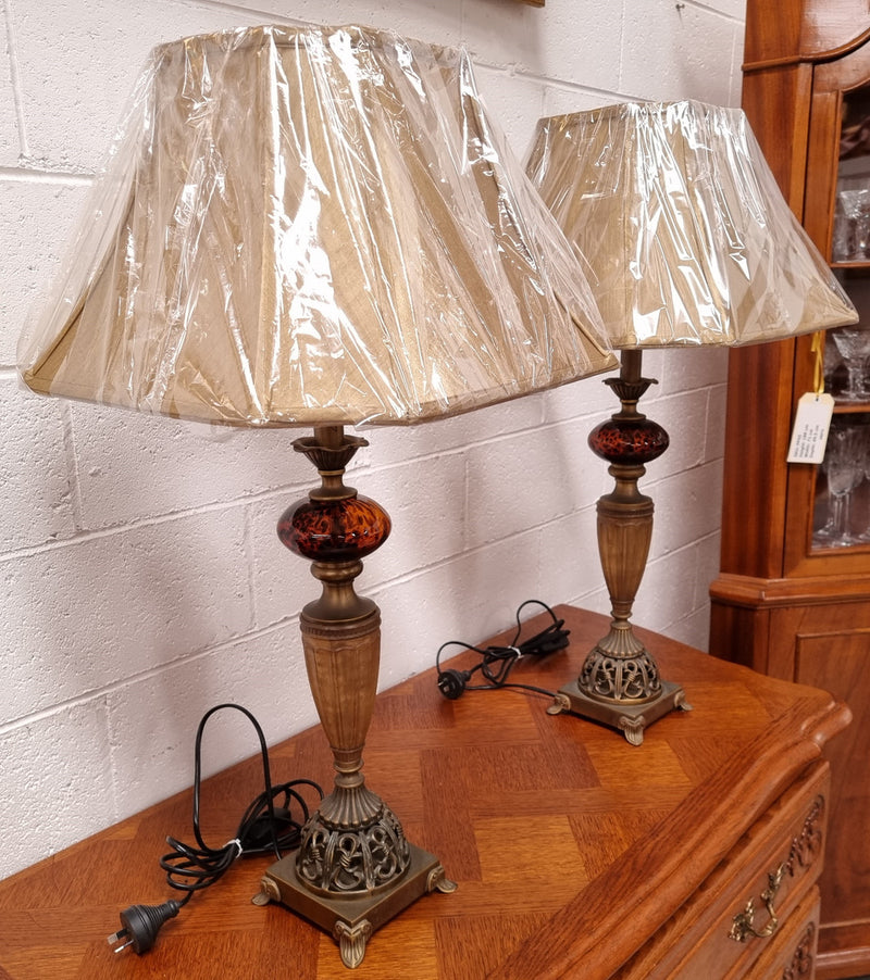 Beautiful pair of metal and glass lamp bases with new gold shades. They are in good original working condition and have been sourced locally.