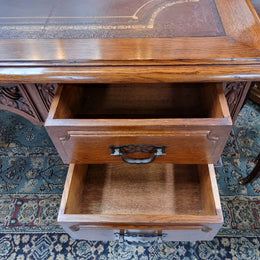 Substantial French Louis XVI style Oak partners desk. It has a beautiful leather top, two drawers on either side and decorative carvings throughout. Sourced from France and in good original detailed condition.
