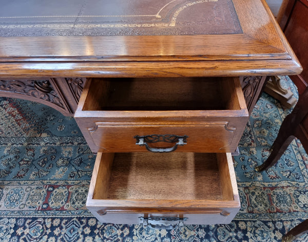 Substantial French Louis XVI style Oak partners desk. It has a beautiful leather top, two drawers on either side and decorative carvings throughout. Sourced from France and in good original detailed condition.