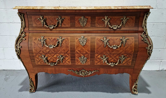A beautifully inlaid parquetry three drawer commode with a lovely marble top, and decorative ormolu mounts. In good original detailed condition. Circa 1930
