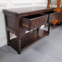 Rare size 19th Century English oak dresser base. It has two good size drawers and amazing patina. It has been sourced from France and in good original detailed condition.