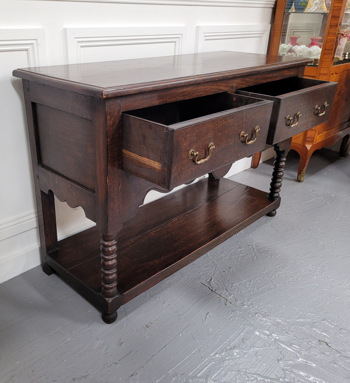 Rare size 19th Century English oak dresser base. It has two good size drawers and amazing patina. It has been sourced from France and in good original detailed condition.