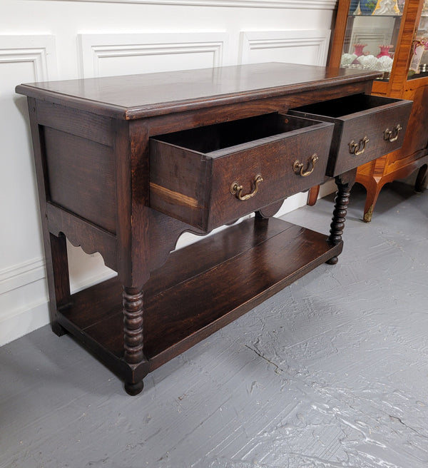 Rare size 19th Century English oak dresser base. It has two good size drawers and amazing patina. It has been sourced from France and in good original detailed condition.