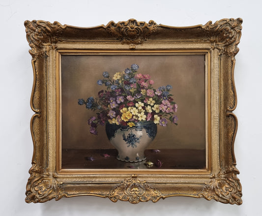 Attractive signed oil on canvas depicting flowers in a blue and white Jardinière in a stunning gilt frame. In good original detailed condition.