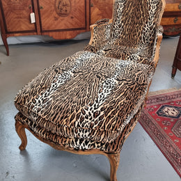 A French Louis XV style armchair with leopard print upholstery and with matched footstool. Fabric is in good original used condition. Please view photos as they help form part of the description.