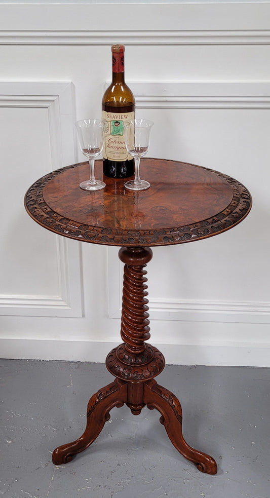 Rare early Victorian Irish Burr Walnut wine table. It has a beautiful carvings and a stunning burr walnut top, on a barley twist column and three shaped legs. It has been sourced locally and is in good original detailed condition. We also have a second table being sold separately which when together make a matched pair.