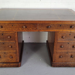 English Oak double pedestal desk with a tooled leather top . It has eight drawers in total and is in good original condition.
