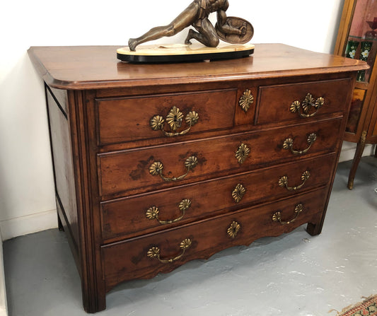 Stunning French 18th Century Walnut commode with beautiful hardware. In good original detailed condition.