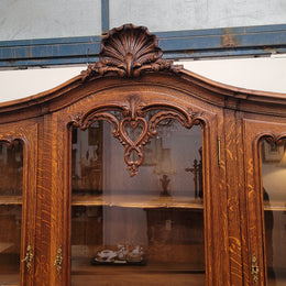 Impressive French Oak Louis 14th Style Display and Sideboard. It has 4 drawers, 2 bottom cupboards with 6 total shelves and 3 display doors with 3 shelves.  In good, detailed condition.