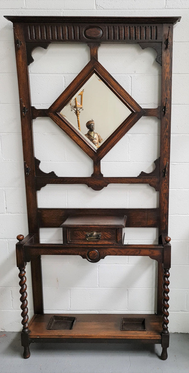 Beautiful Oak Antique Jacobean hall stand, with barley twist leg and a drawer for storage in very good original detailed condition condition.