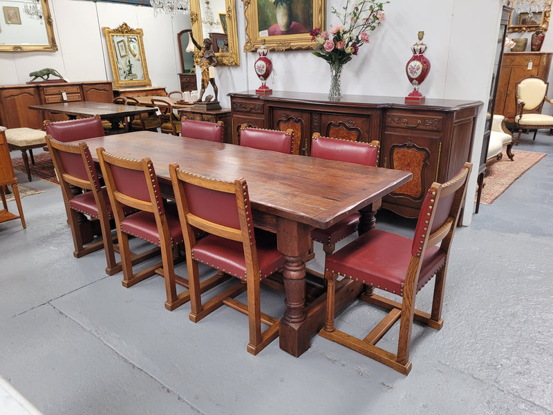 Charming solid rustic Oak stretcher base Farmhouse table. The table is circa 1950's and was custom made using reclaimed oak. It comfortable sits eight and could seat 10. It is in good original detailed condition.