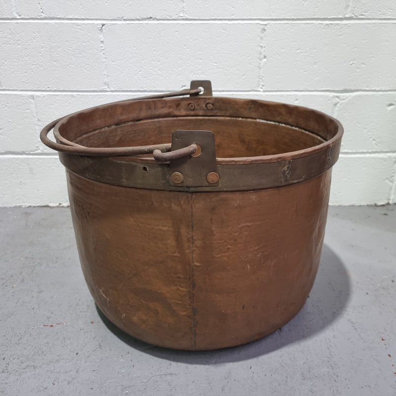 Large Antique French copper cauldron with metal band around rim. It is in good original condition.