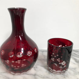 Vintage flash ruby glass water carafe with matching drinking glass.