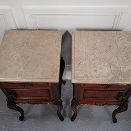 Pair of French Antiloopque Louis XV style Walnut and marble top bedsides. They have lovely carvings along with a drawer and cupboard space. They are in good original detailed condition and have been sourced from France
