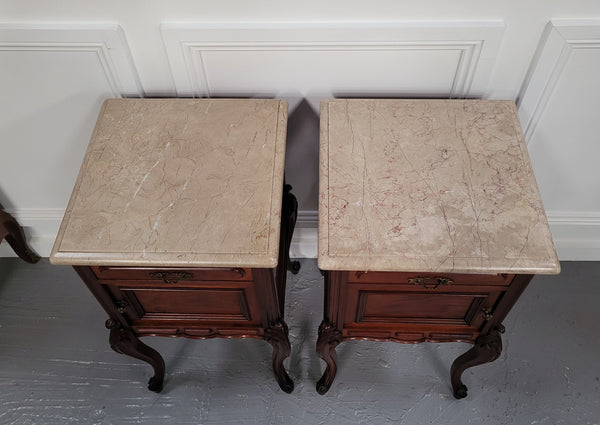 Pair of French Antiloopque Louis XV style Walnut and marble top bedsides. They have lovely carvings along with a drawer and cupboard space. They are in good original detailed condition and have been sourced from France