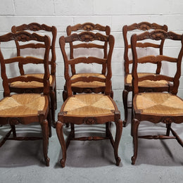 Lovely set of six French oak rush seated provincial dining chairs. They have been sourced from France and are in good detailed condition.