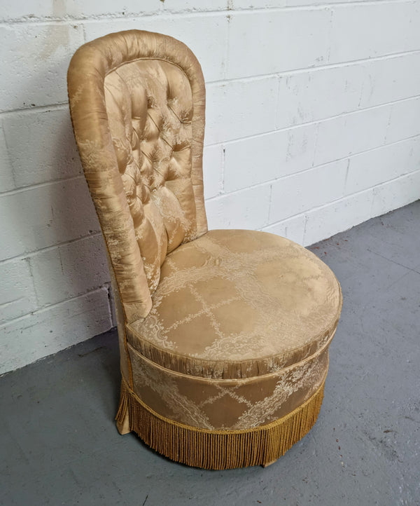 Vintage round upholstered button back bedroom chair. Beautiful gold upholstery in original condition with a gold fringe.