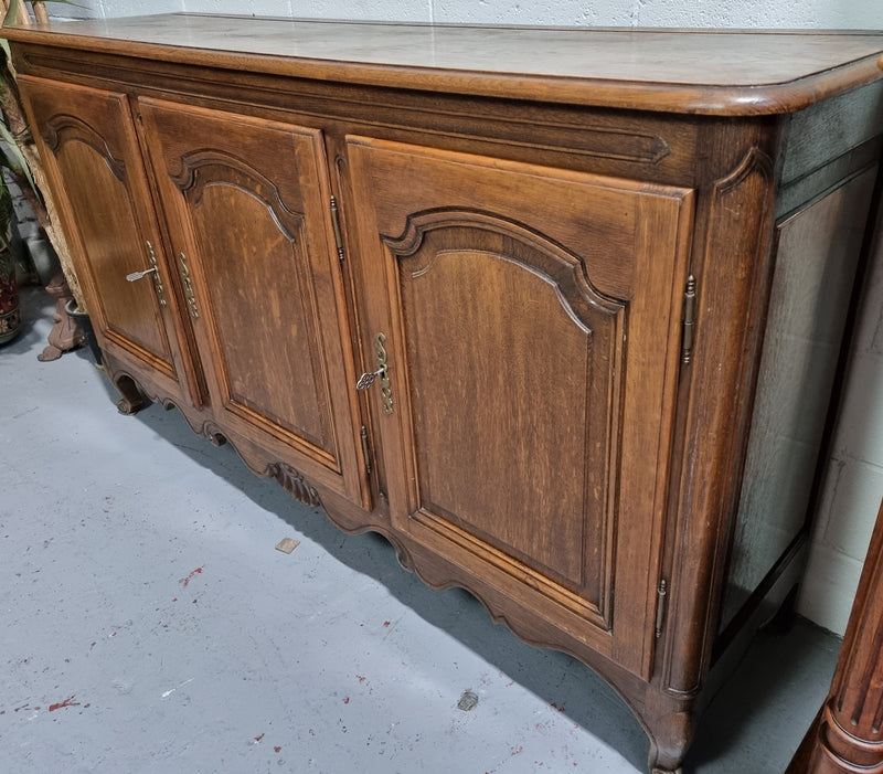 Charming French Louis 15th style sideboard with three doors and a stunning wooden top. In good detailed condition. Circa 1900