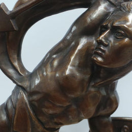 An Art Deco large signed bronze statue, on a marble base showing strength by renowned artist Salvatore Megani. The statue is in good original condition.