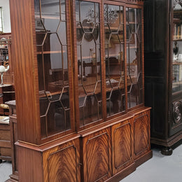 Georgian style Breakfront Flame Mahogany four door bookcase. A very impressive piece with plenty of storage and is of pleasing narrow proportions. It has been sourced locally and is in good original detailed condition.
