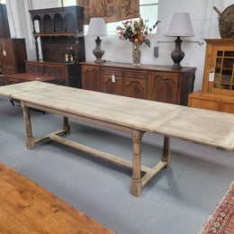 Beautilful raw solid oak French pedestal extension table. It has been sourced from France and is in good original detailed condition. When the table is fully extended it is 339 cm long and can comfortable seat 10-12 people. Features raw wood that could be used as is for a distressed look, or finished and waxed for a more refined look.